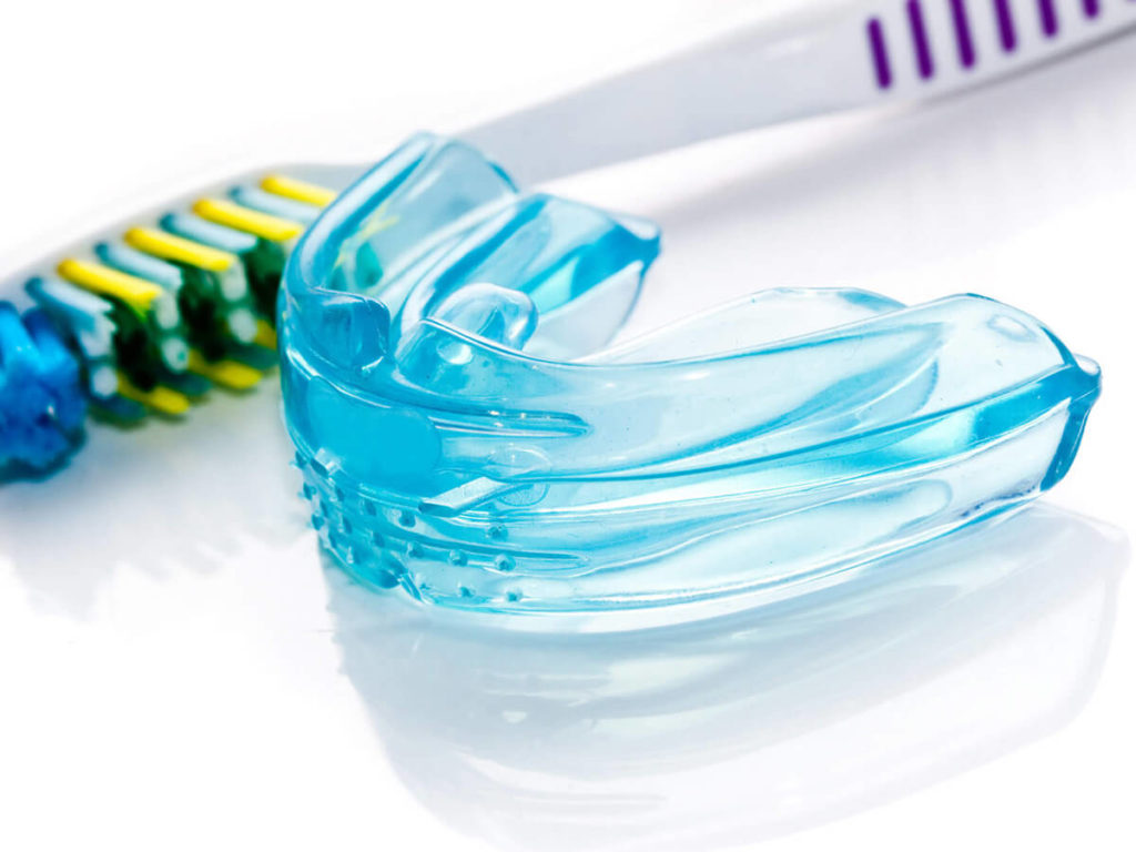 mouth guard with a toothbrush on a white background