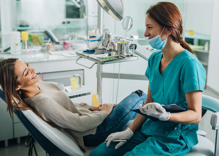 smiling patient making eye contact with a smiling hygienist
