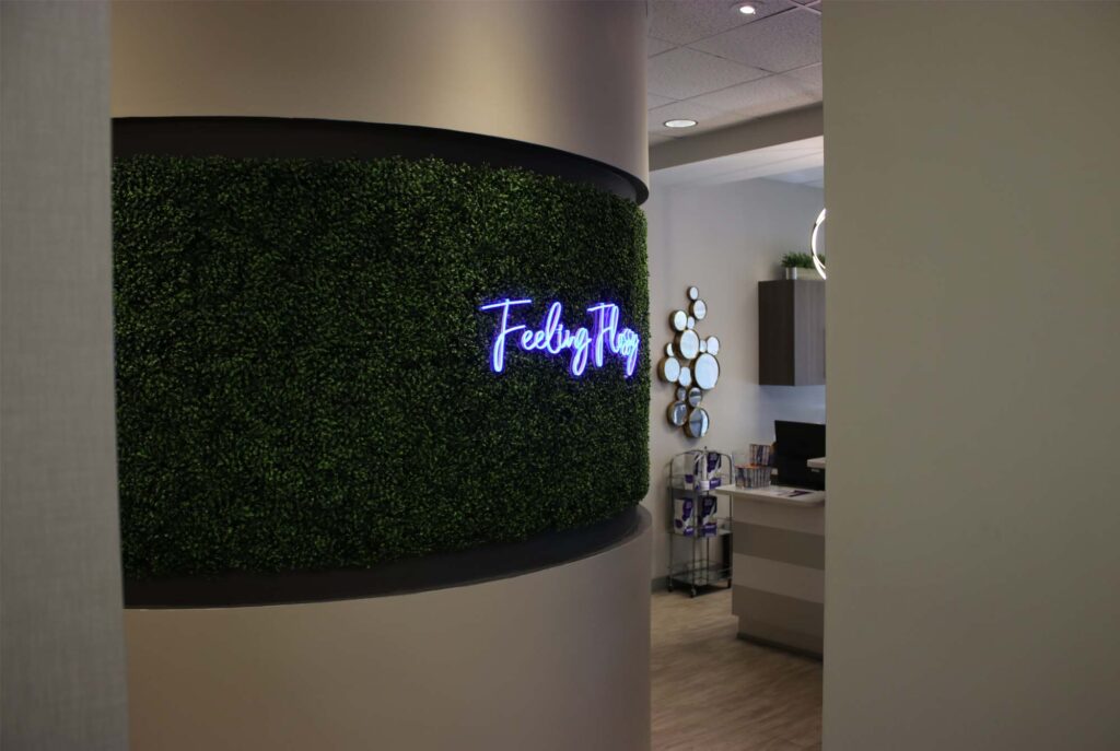 "Feeling Flossy" sign inside Stiles Dental Group on a faux leafy green background